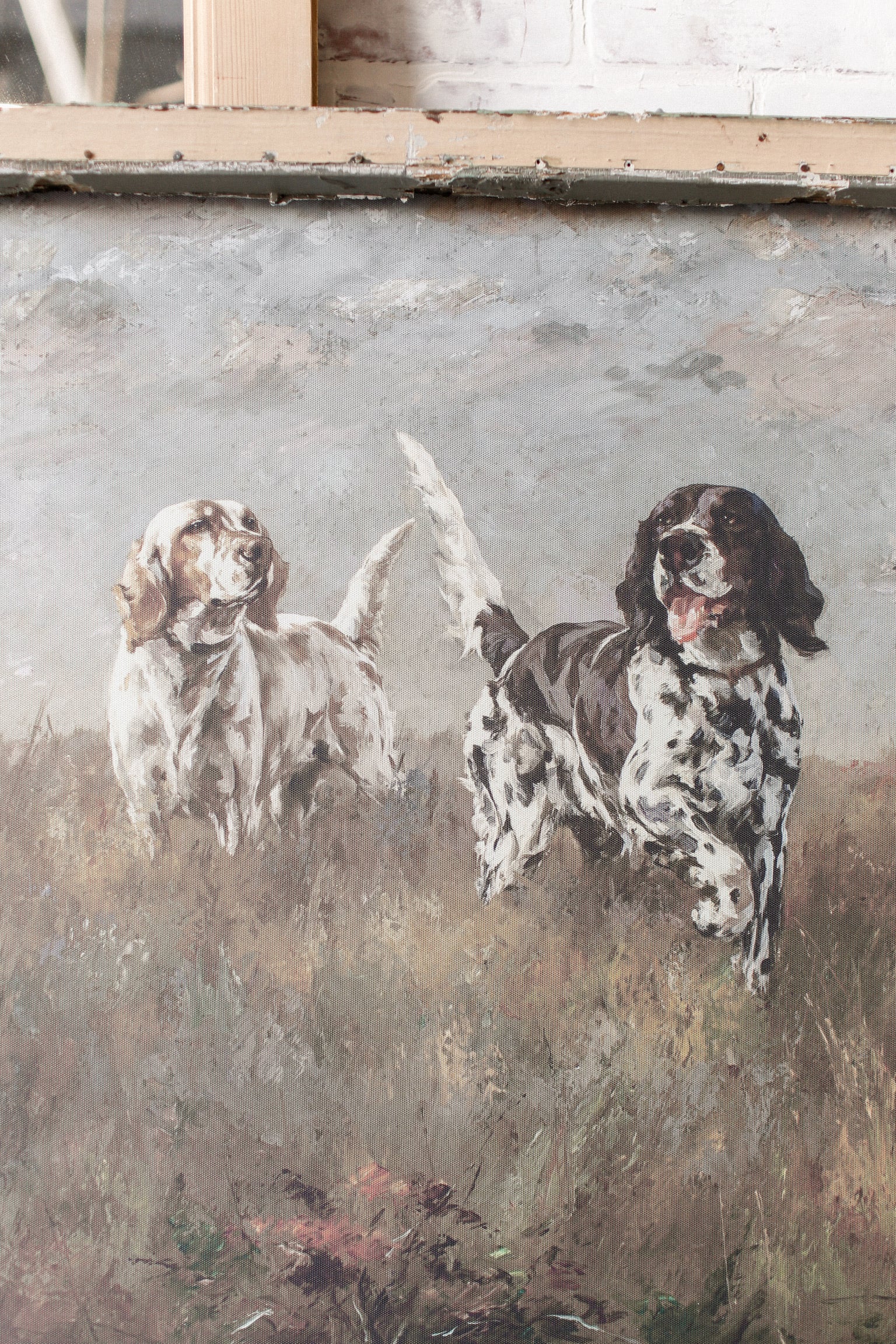 Vintage artwork of two dogs in a field framed in a rustic gray salvaged window frame